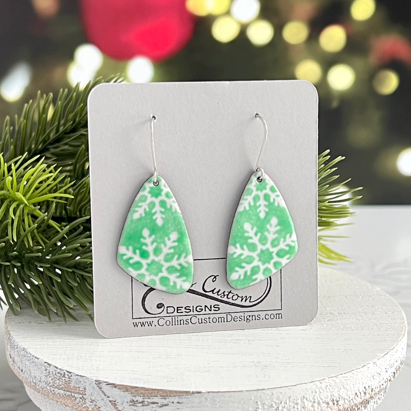 Green Enamel Asymmetrical Earrings With White Partial Snowflakes