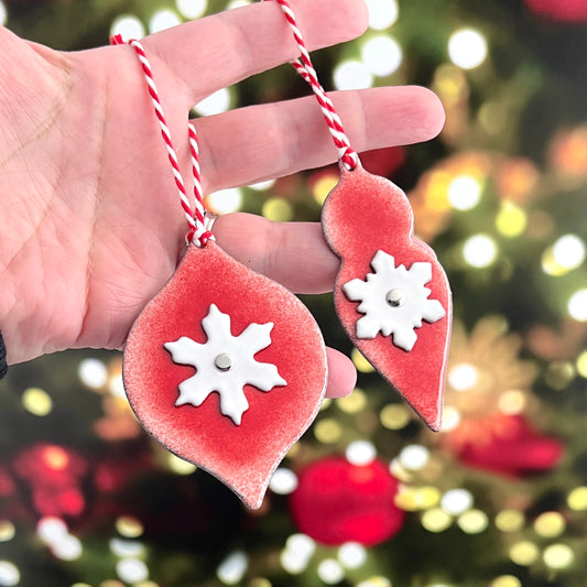 Red Enamel Ornament With a White Enamel Snowflake