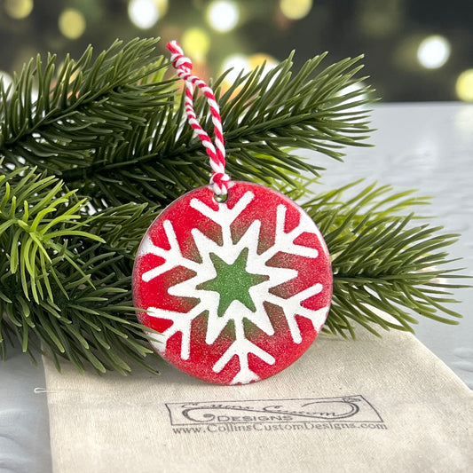 Red and Green Round Ornament With White Snowflake